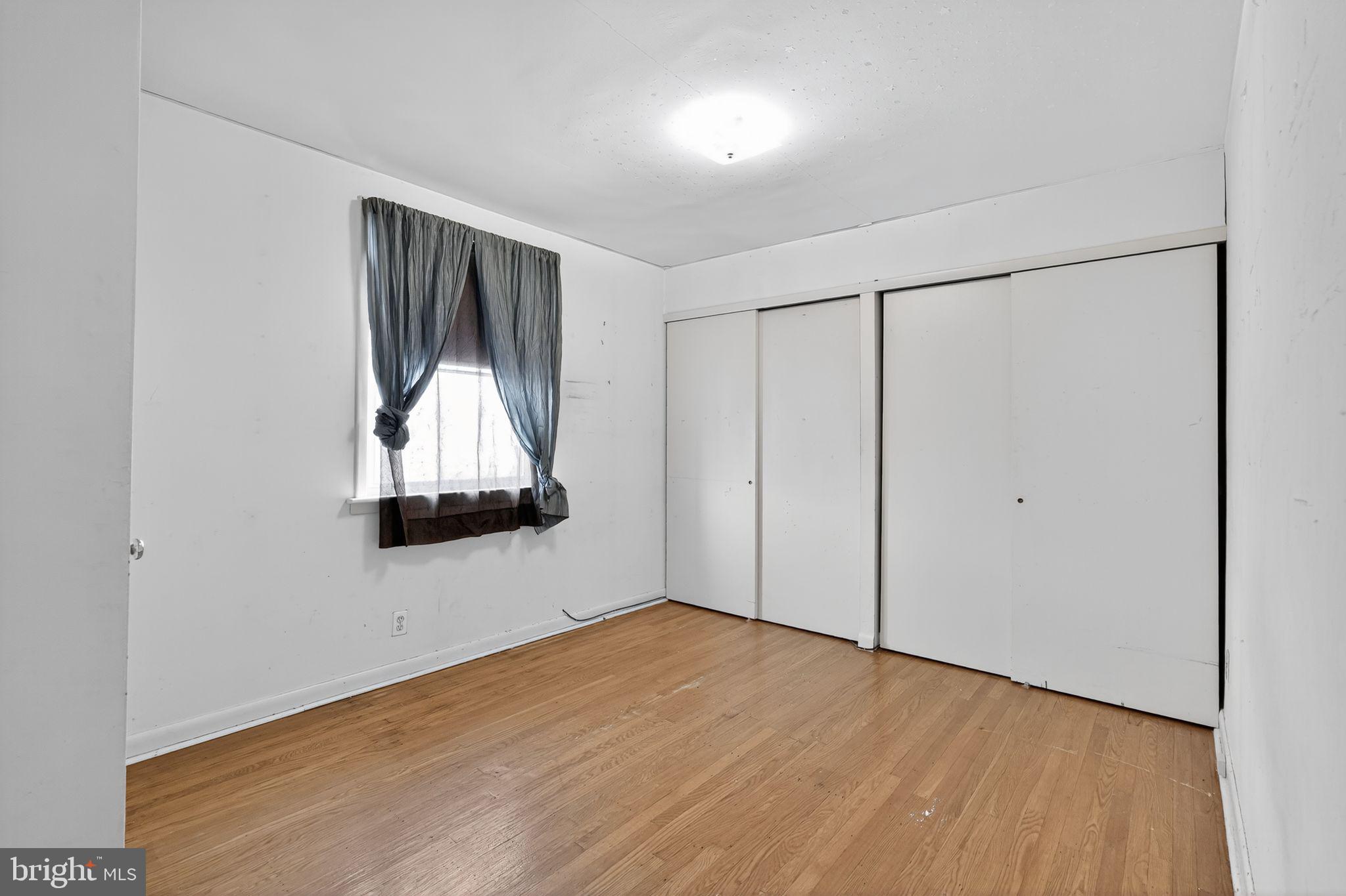 1711 Kendrick Street Philadelphia, PA 19152 - Photo 22 of 29 a view of an empty room with wooden floor and a window
