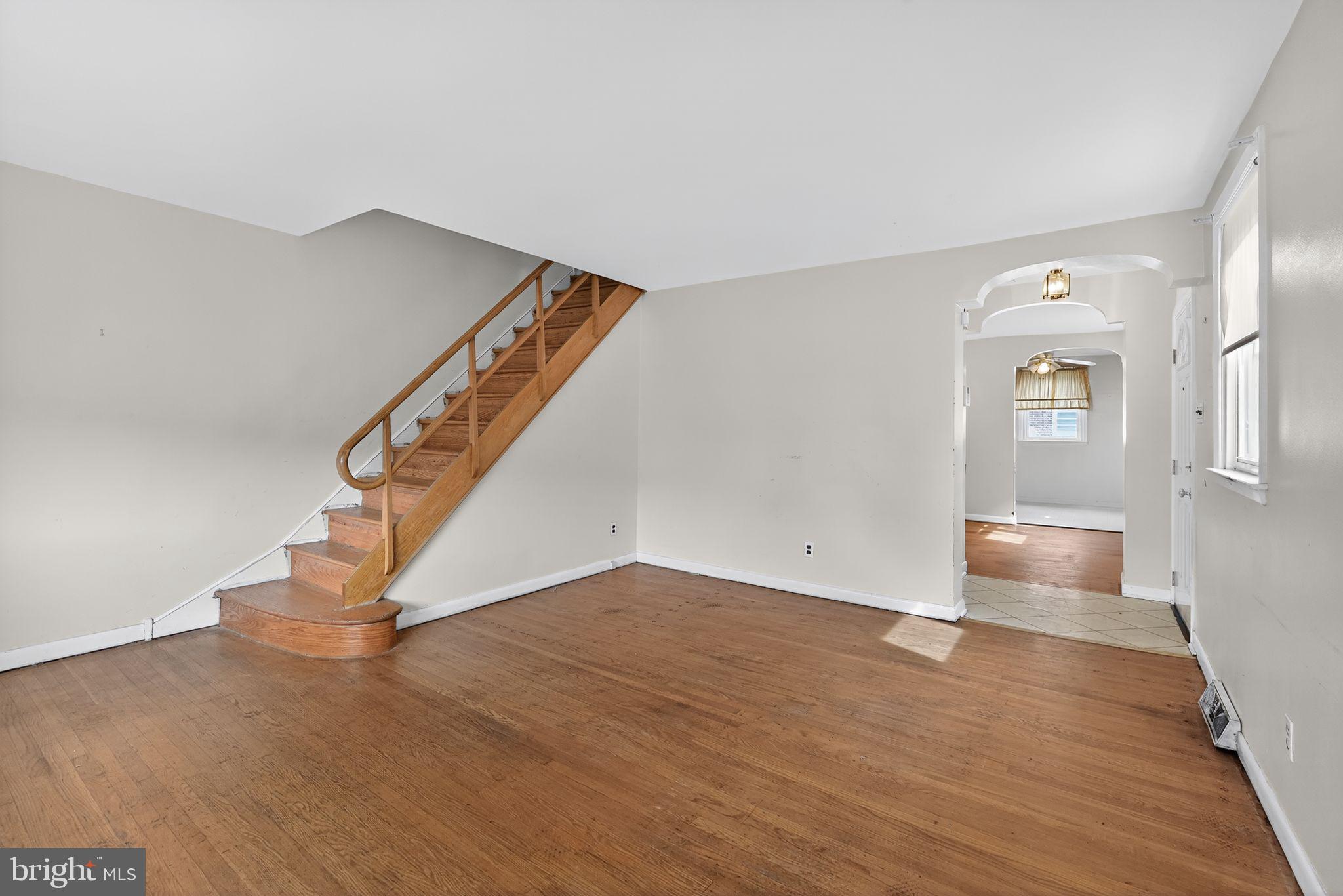 1711 Kendrick Street Philadelphia, PA 19152 - Photo 4 of 29 a view of an empty room with wooden floor and stairs