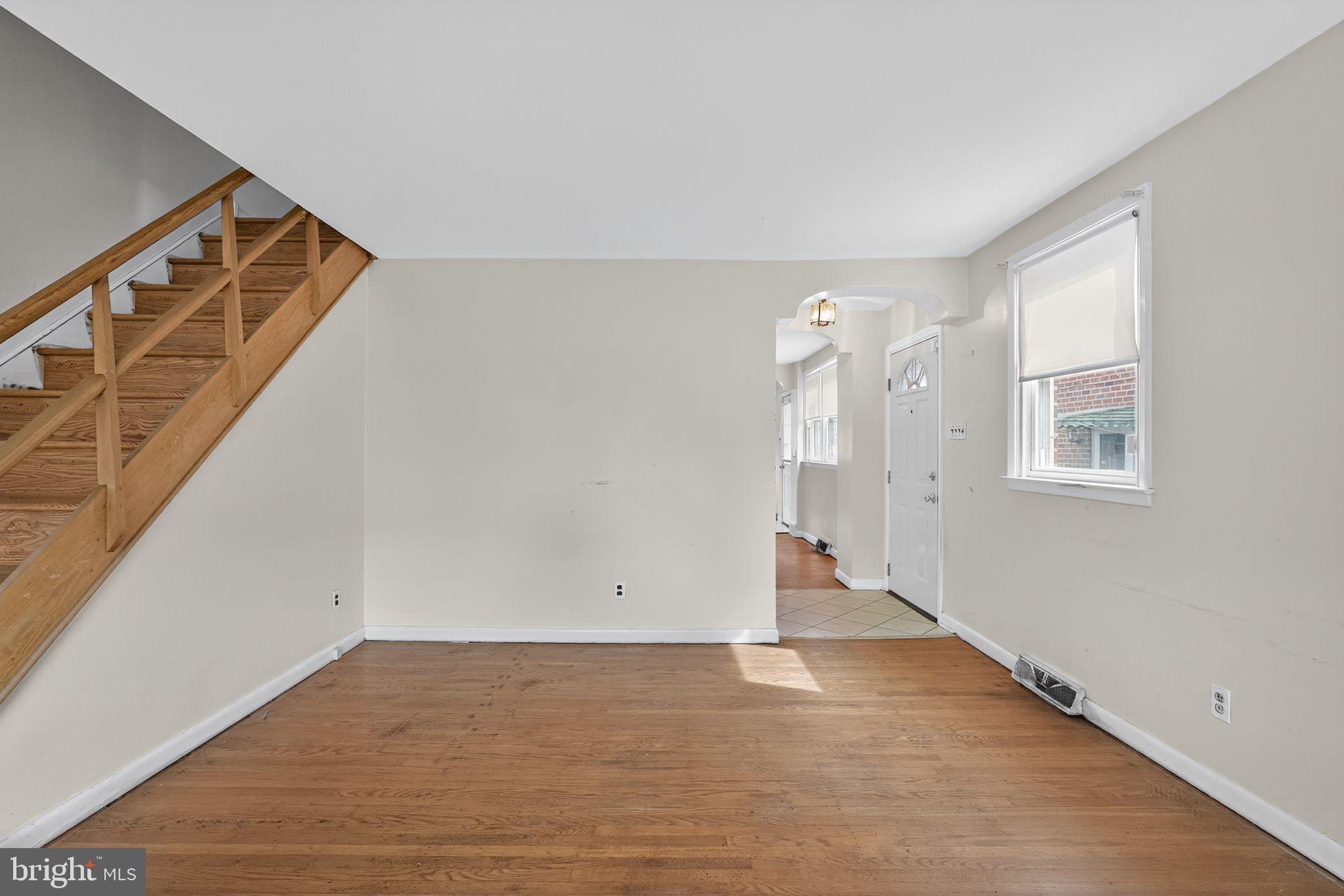 1711 Kendrick Street Philadelphia, PA 19152 - Photo 5 of 29 a view of an empty room with wooden floor and stairs