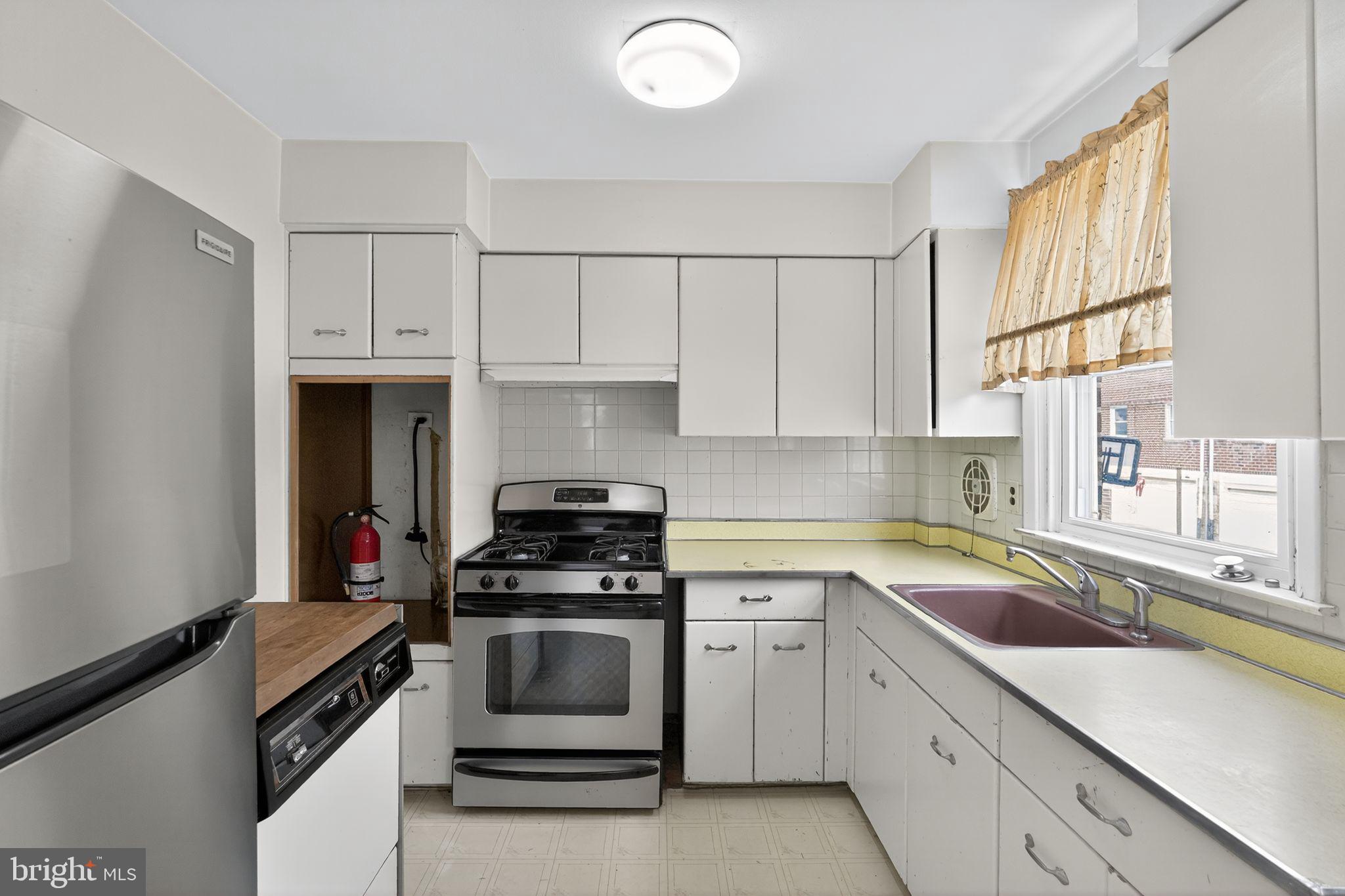 1711 Kendrick Street Philadelphia, PA 19152 - Photo 9 of 29 a kitchen with white cabinets and white appliances