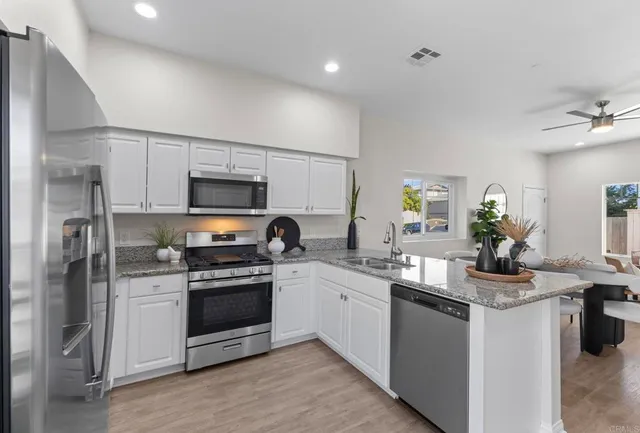 a kitchen with a sink stove and refrigerator