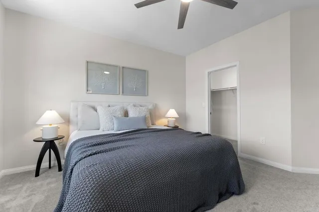 a bedroom with a bed and a lamp