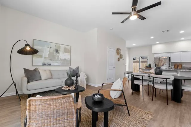 a living room with furniture a rug and white walls