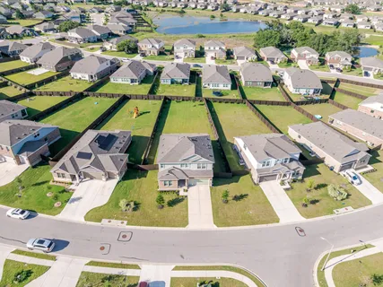 an aerial view of residential houses with outdoor space