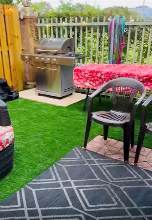 a view of a patio with a table chairs and a potted plant