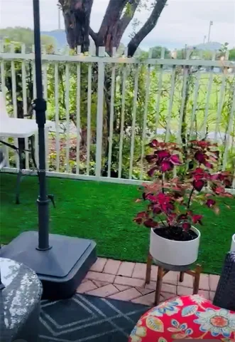 a view of a backyard with garden and flowers