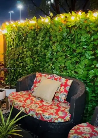 a bedroom with a bed and a lamp on dresser