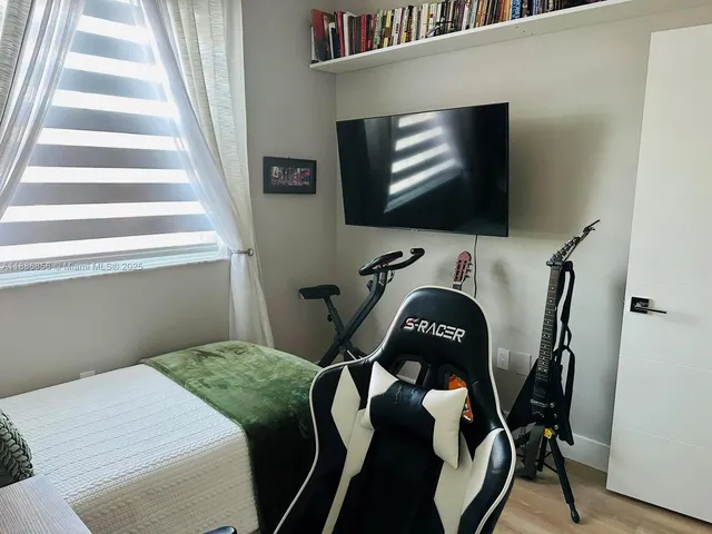a white toilet sitting next to a shower