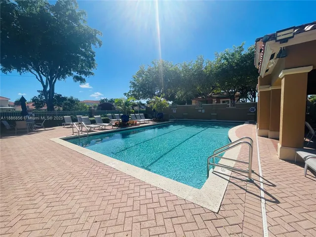 a view of a house with pool and sitting area