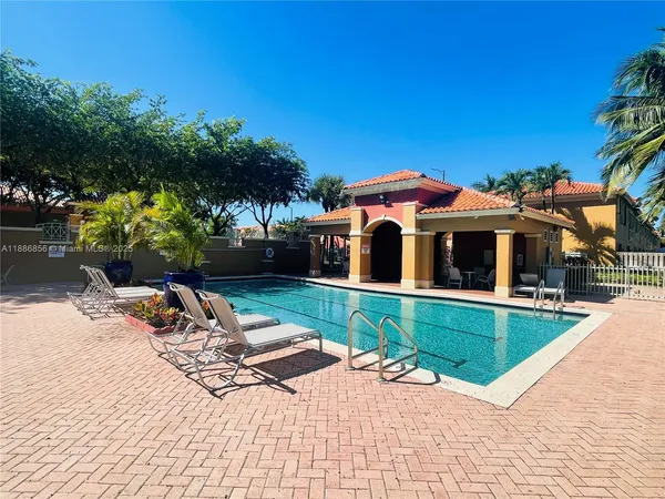 a dining room with furniture and a floor to ceiling window