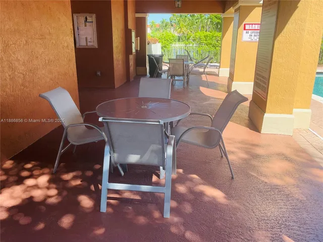 a view of a backyard with sitting area