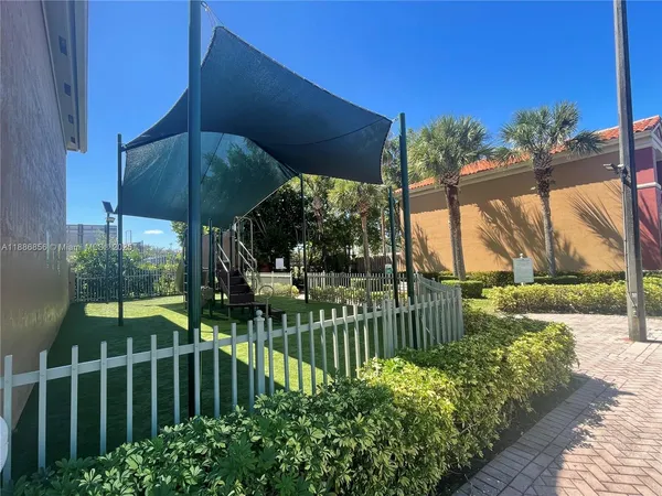 a view of a deck with a table and chairs under an umbrella