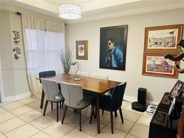 a view of a dining room with furniture and chandelier