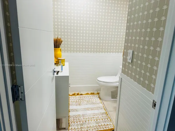 a bathroom with a toilet and a shower curtain