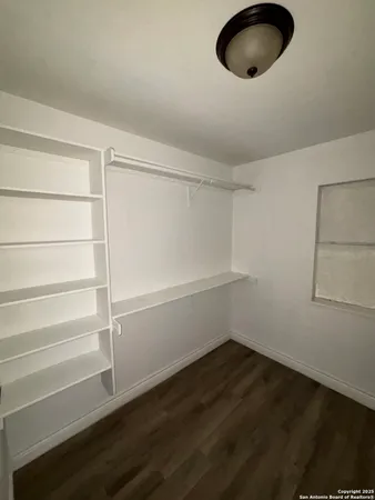 a view of a room with wooden floor