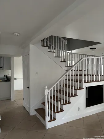 a view of staircase with white walls and stairs