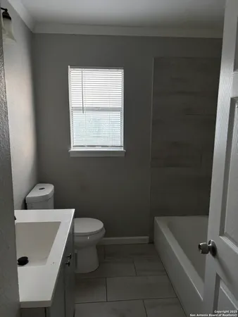 a bathroom with a sink a toilet and a bathtub