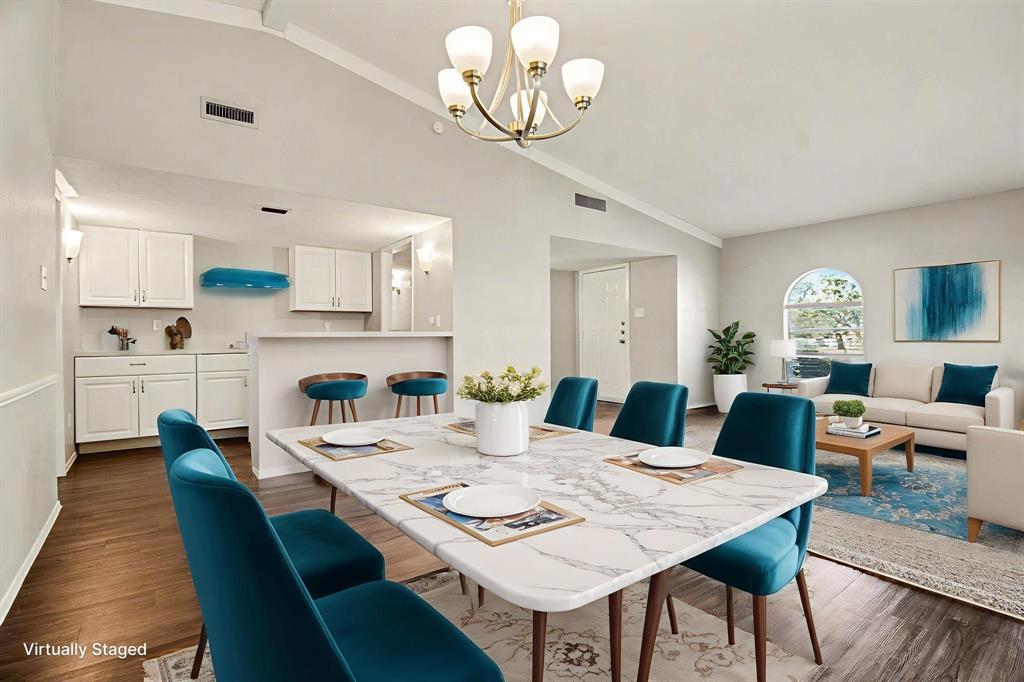 6532 Blue Ridge Trail Plano, TX 75023 - Photo 11 of 25 a view of a dining room with furniture a chandelier and wooden floor