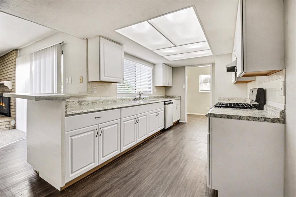 6532 Blue Ridge Trail Plano, TX 75023 - Photo 13 of 25 a kitchen with sink stove and cabinets