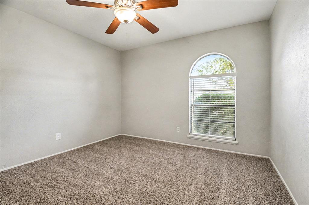 6532 Blue Ridge Trail Plano, TX 75023 - Photo 16 of 25 an empty room with windows and fan