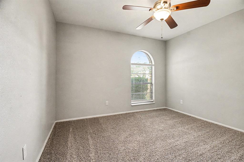 6532 Blue Ridge Trail Plano, TX 75023 - Photo 20 of 25 an empty room with windows and fan