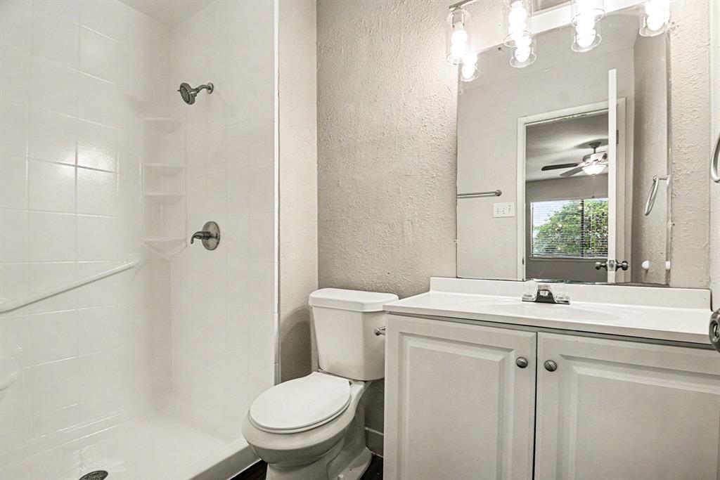6532 Blue Ridge Trail Plano, TX 75023 - Photo 22 of 25 a bathroom with a sink toilet vanity and shower