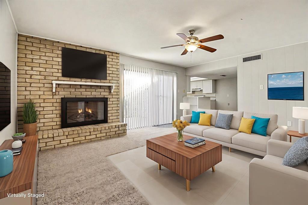 6532 Blue Ridge Trail Plano, TX 75023 - Photo 10 of 25 a living room with furniture a fireplace and a flat screen tv