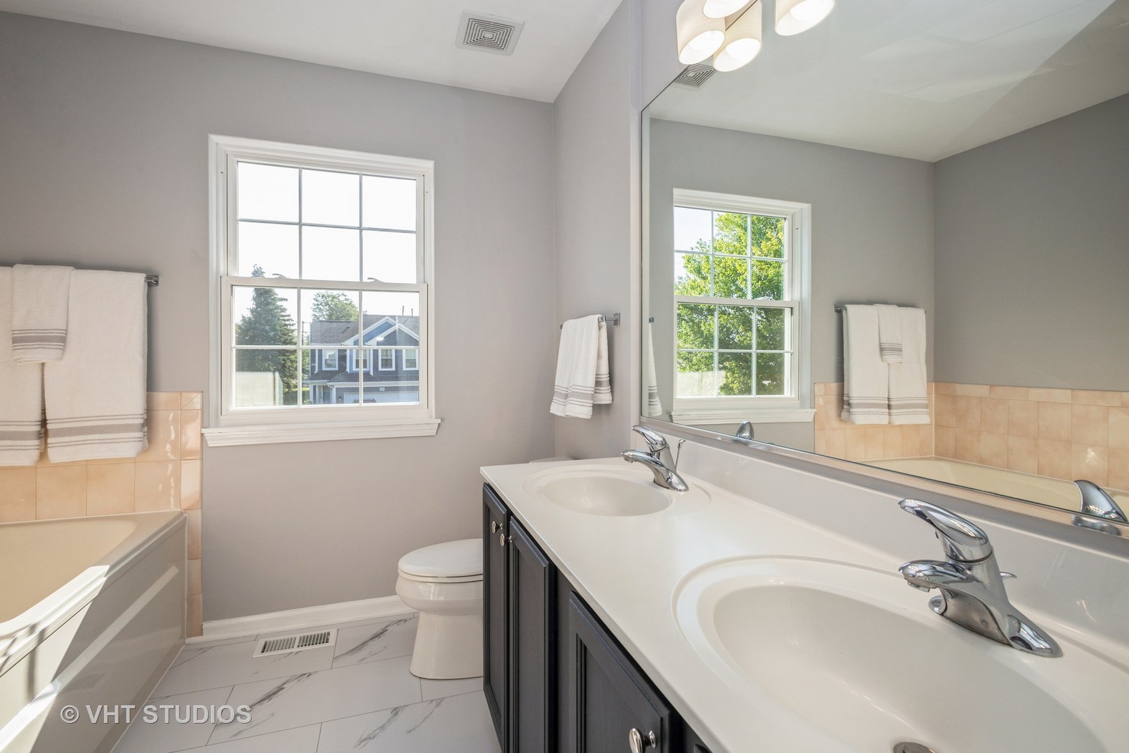 104 Millers Crossing Itasca, IL 60143 - Photo 6 of 11 a bathroom with a granite countertop sink a toilet and a window