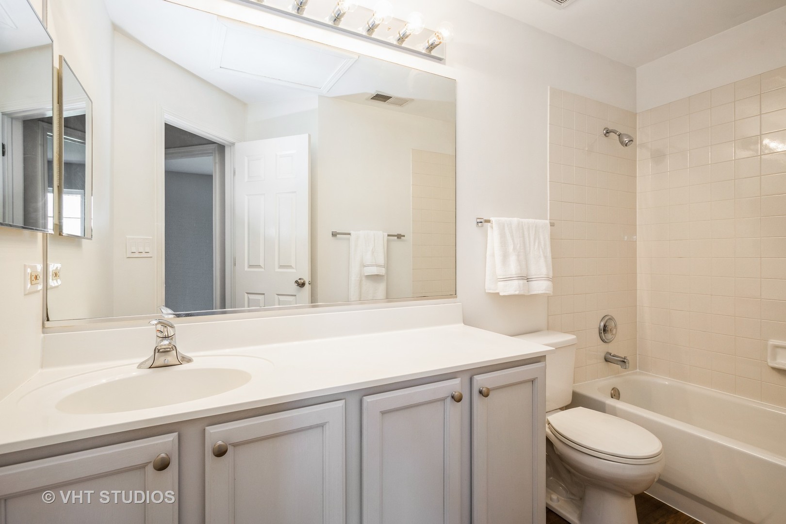 104 Millers Crossing Itasca, IL 60143 - Photo 9 of 11 a bathroom with a sink toilet a mirror and shower