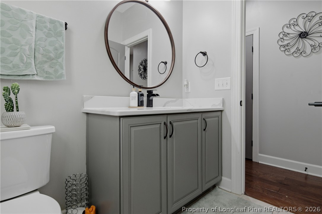 148 Heatherspring Way Spring Lake, NC 28390 - Photo 39 of 50 a bathroom with a toilet a sink and a mirror