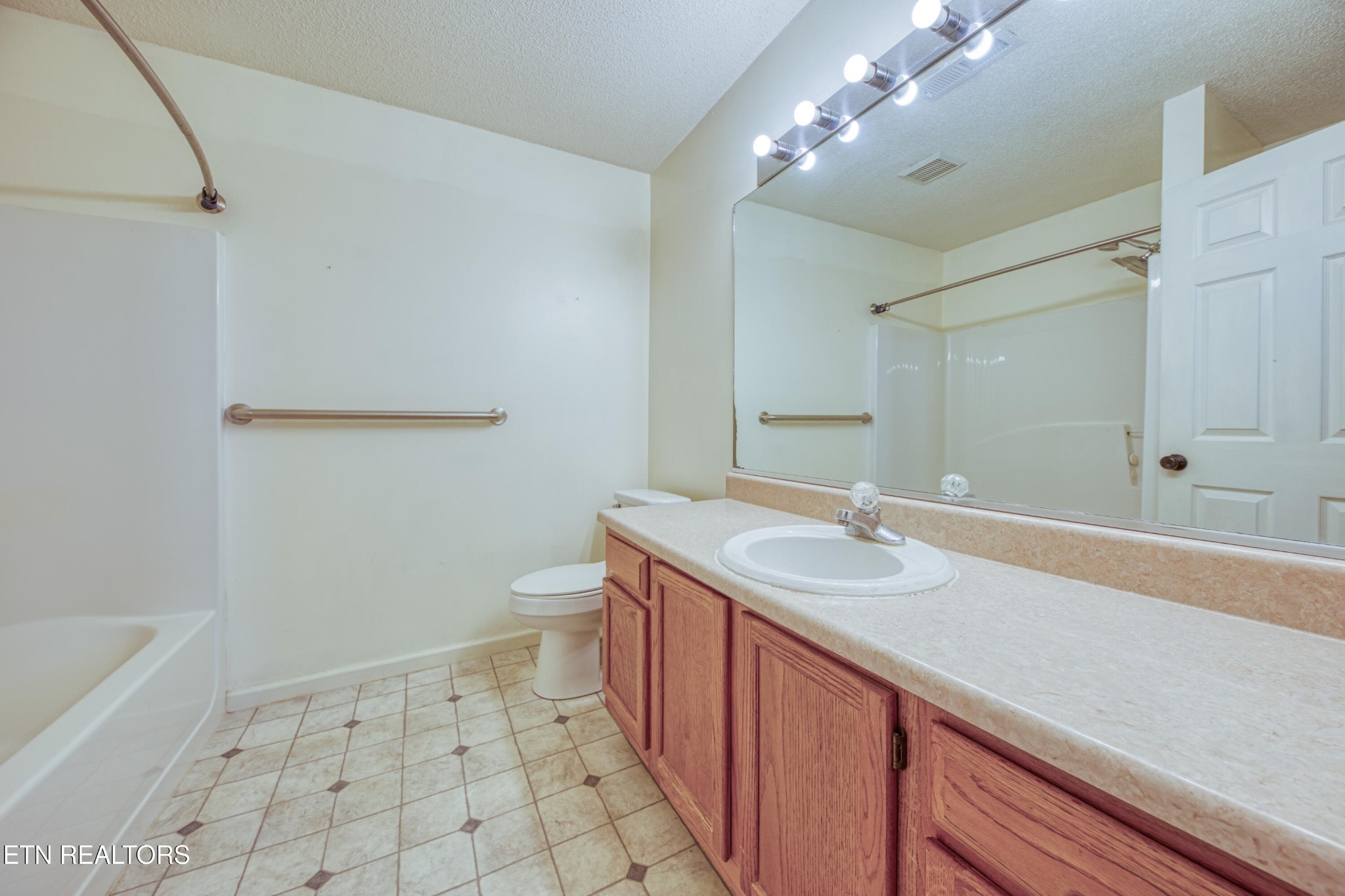 8024 Keybridge Way Powell, TN 37849 - Photo 17 of 23 a bathroom with a sink a toilet a mirror and bathtub