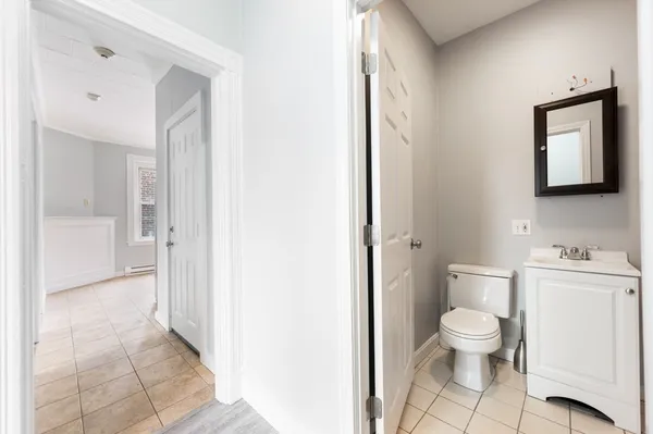 a bathroom with a toilet a sink and a mirror