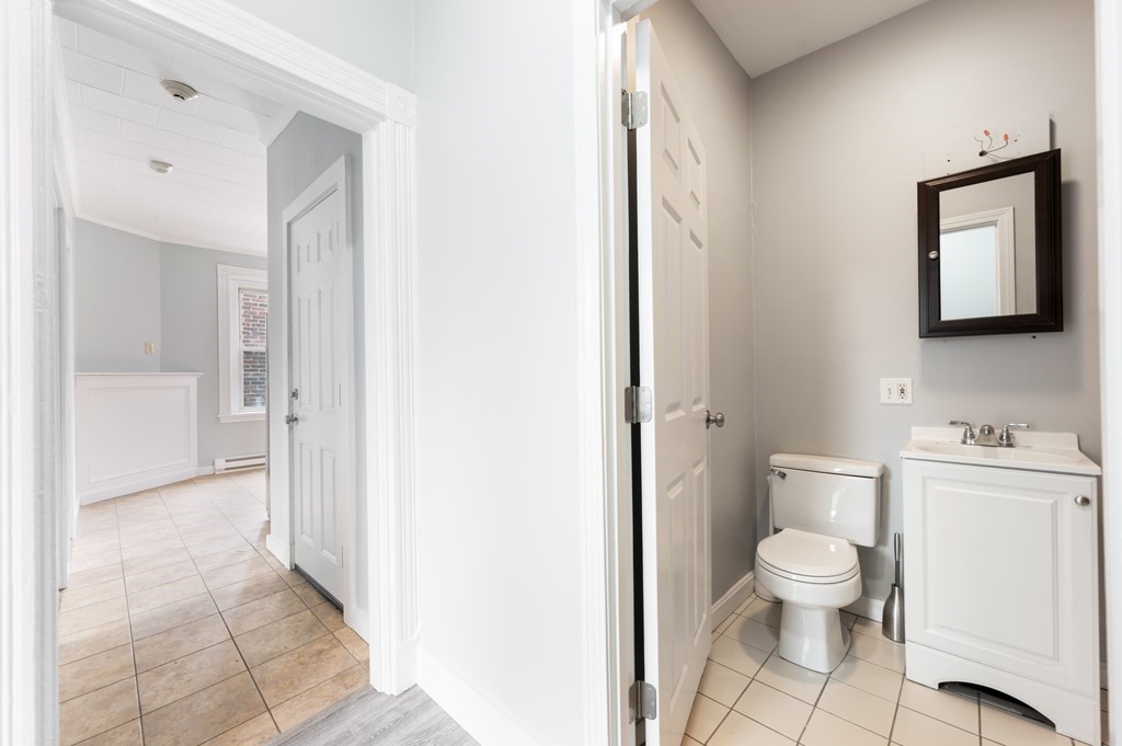 12 Foster Street, Unit 8 Boston, MA 02109 - Photo 12 of 12 a bathroom with a toilet a sink and a mirror