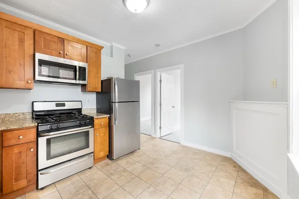 a kitchen with a refrigerator stove and microwave