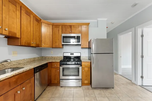 a kitchen with a refrigerator stove and microwave