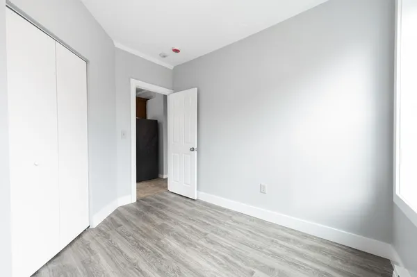 a view of an empty room with wooden floor