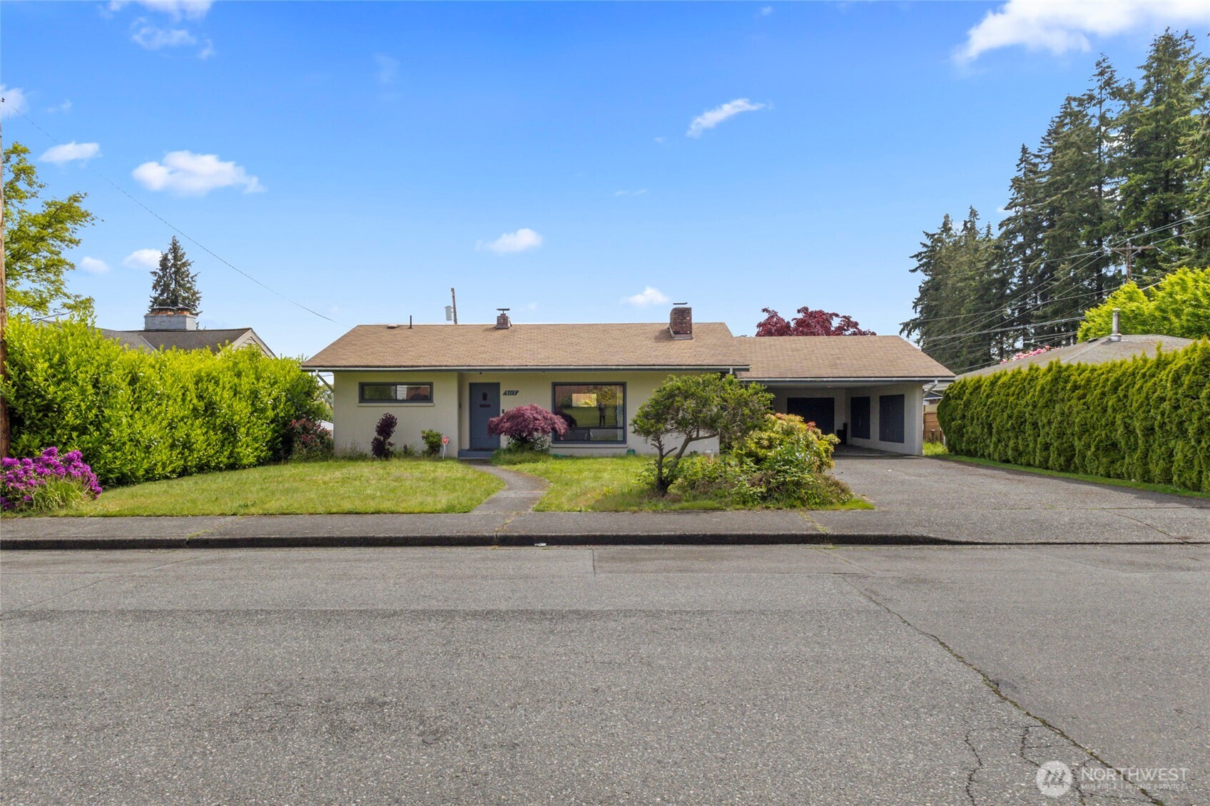 a front view of house with a yard and potted plants