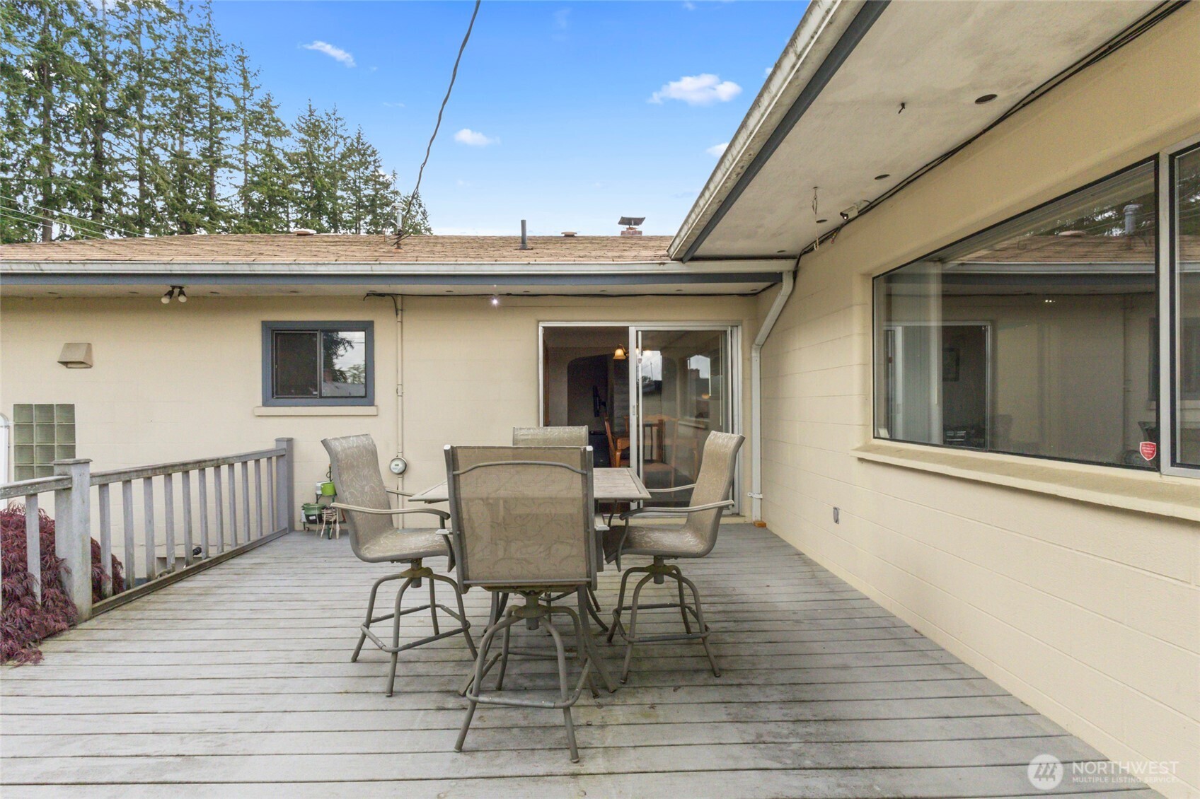 5117 Delaware Avenue Everett, WA 98203 - Photo 21 of 36 a view of a patio with table and chairs and wooden floor