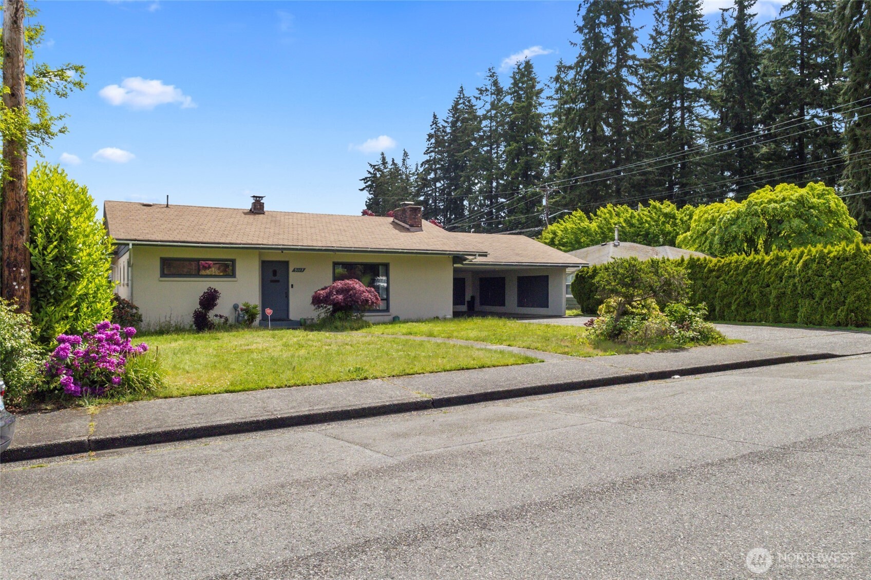 5117 Delaware Avenue Everett, WA 98203 - Photo 31 of 36 a front view of a house with a yard and potted plants