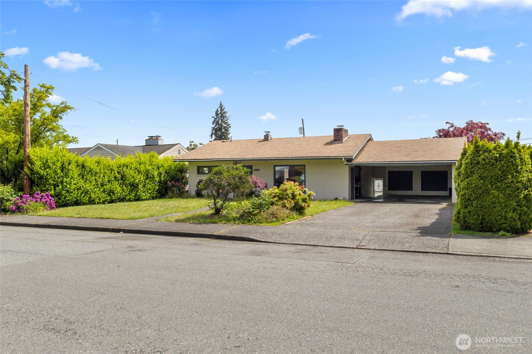5117 Delaware Avenue Everett, WA 98203 - Photo 32 of 36 a front view of a house with a yard and a garage