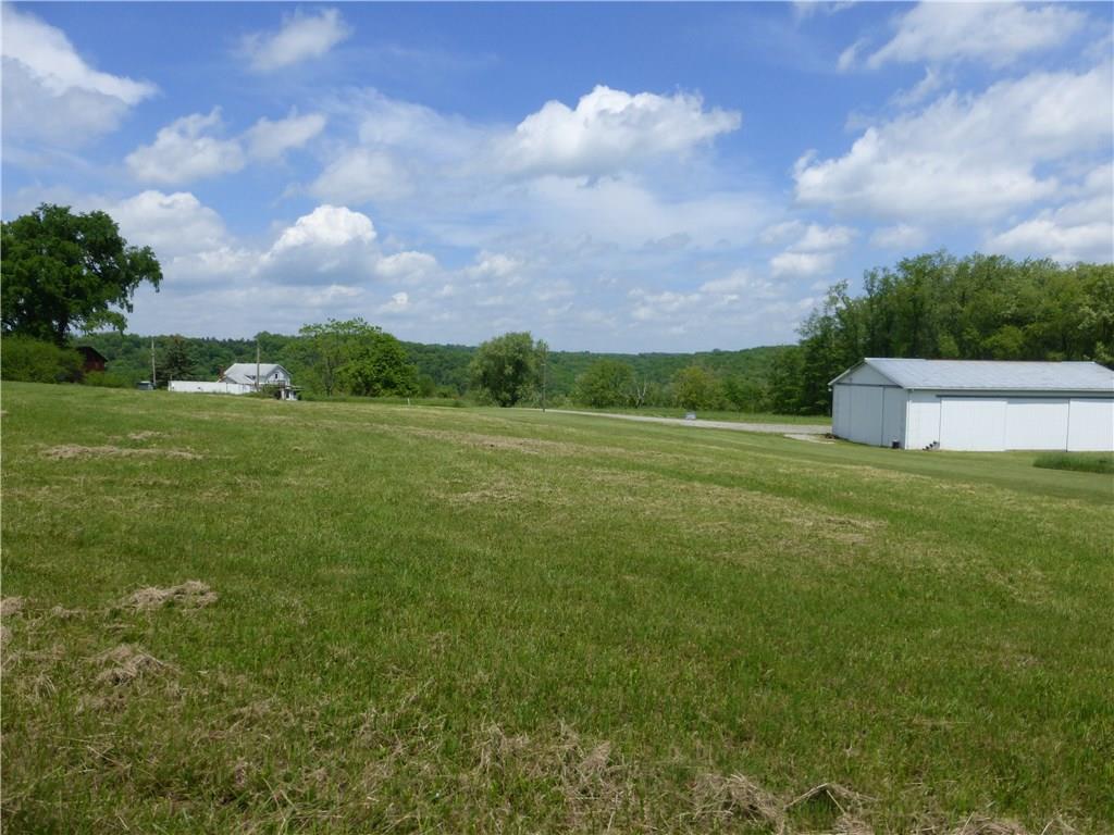 242 Reibold Road Renfrew, PA 16053 - Photo 7 of 14 a view of a big yard with a house in the background