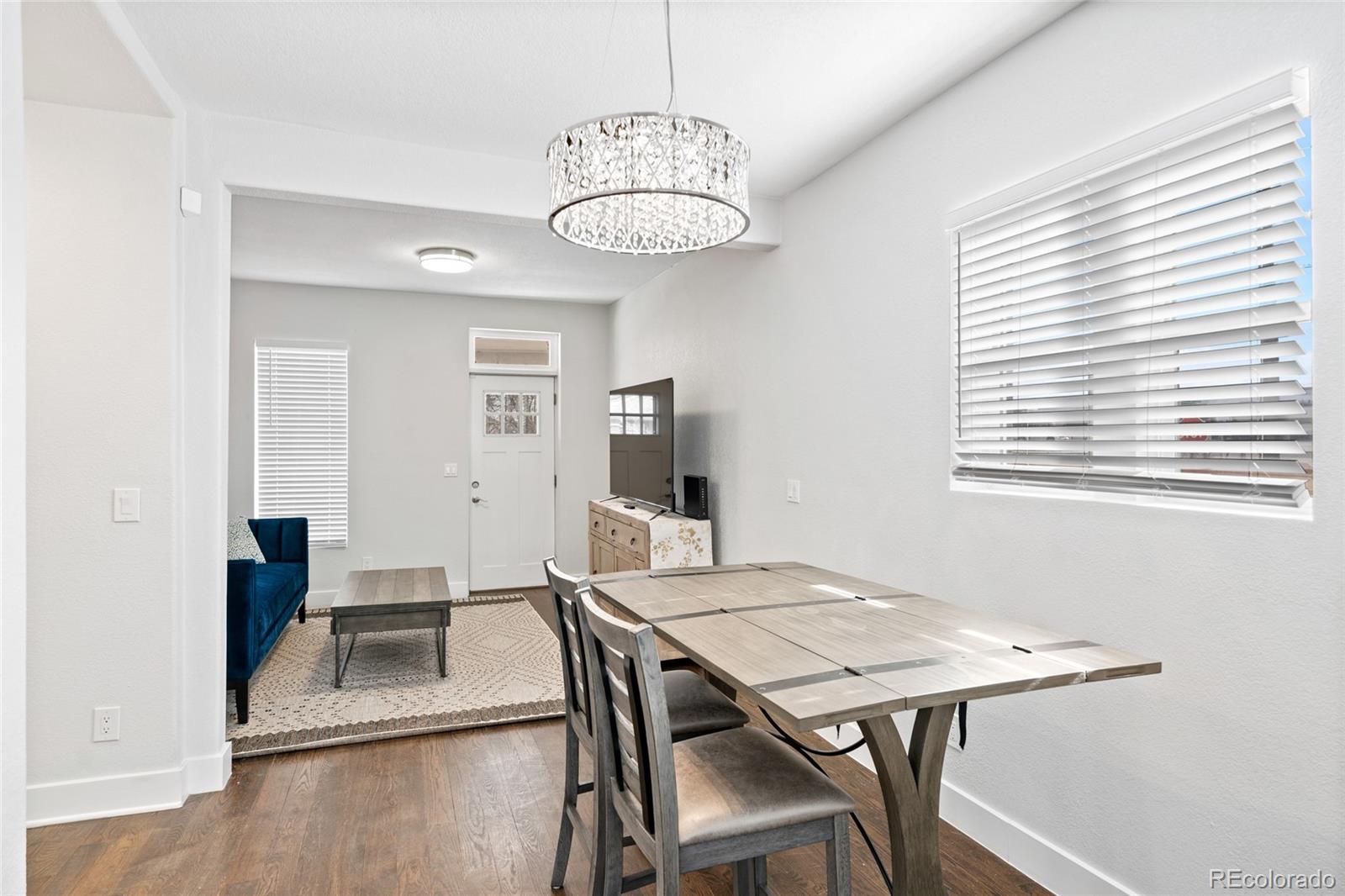 Undisclosed Address Denver, CO 80216 - Photo 11 of 25 a view of a dining room with furniture window and wooden floor