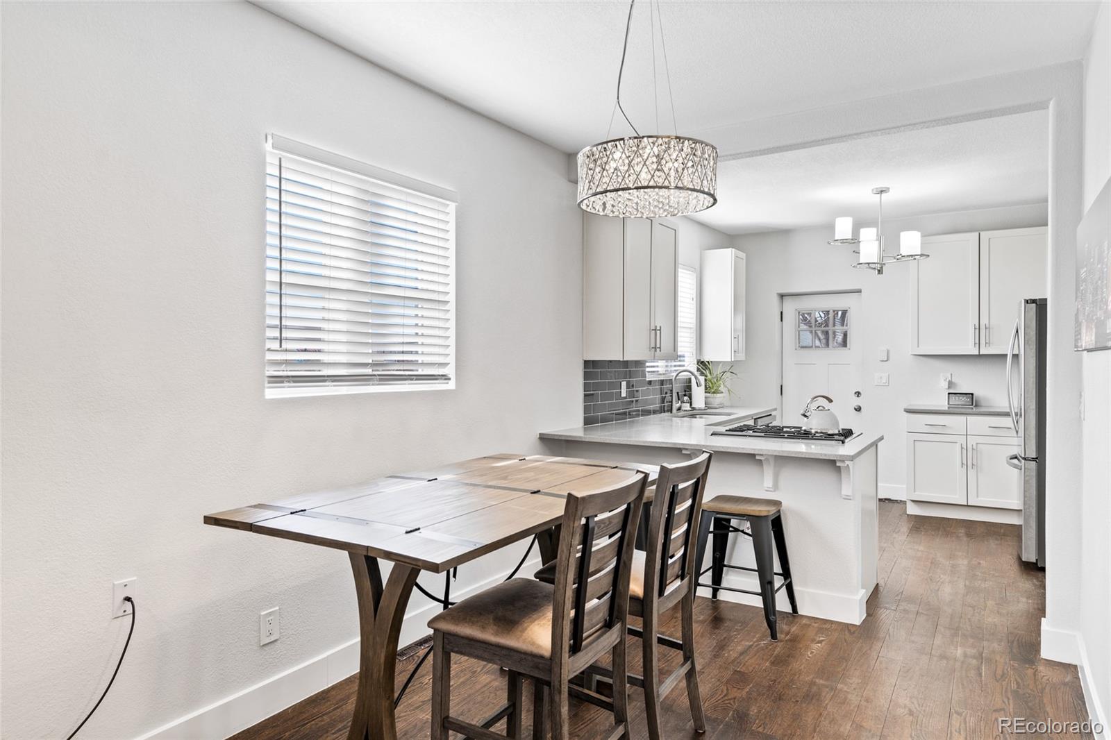Undisclosed Address Denver, CO 80216 - Photo 13 of 25 a view of a dining room with furniture window and wooden floor