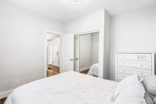 a bedroom with a bed and a mirror