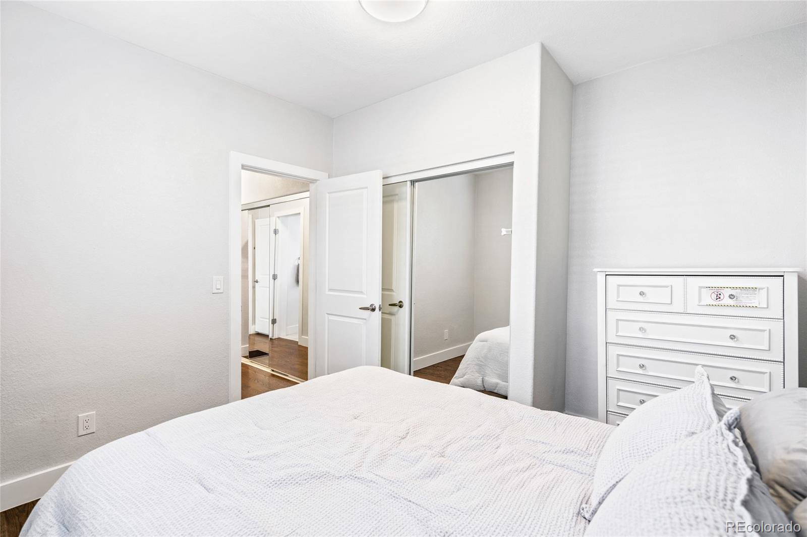 Undisclosed Address Denver, CO 80216 - Photo 17 of 25 a bedroom with a bed and a mirror