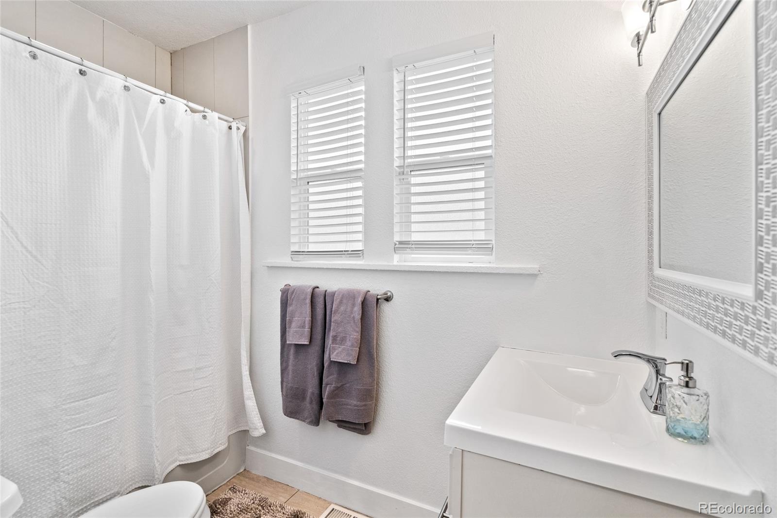 Undisclosed Address Denver, CO 80216 - Photo 18 of 25 a bathroom with a sink and a toilet