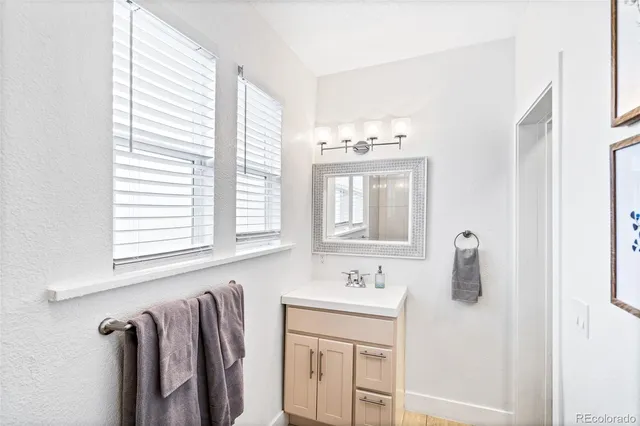 a bathroom with a double vanity sink and mirror