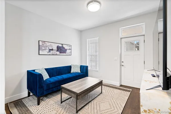 a living room with furniture and a rug