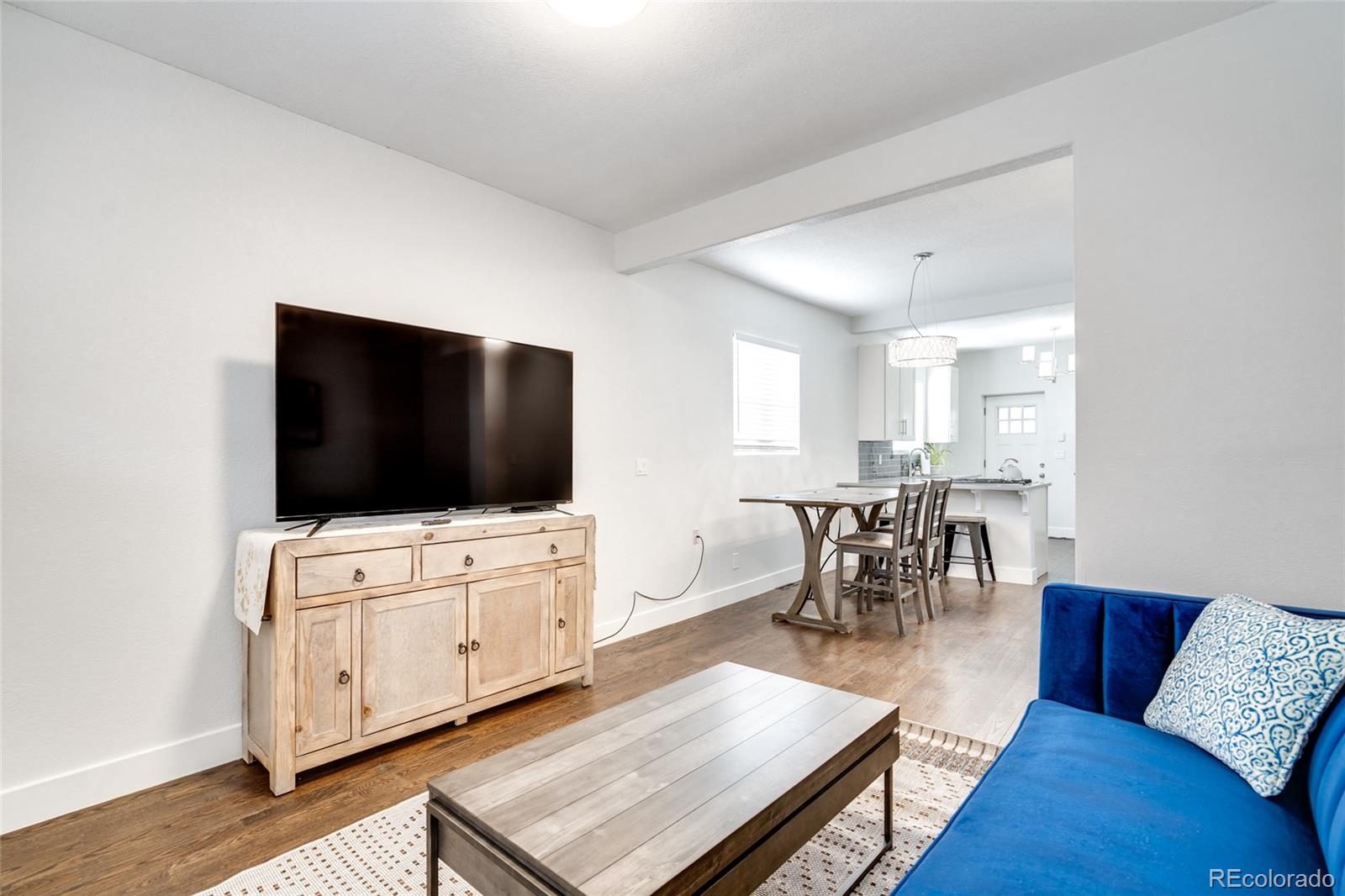 Undisclosed Address Denver, CO 80216 - Photo 5 of 25 a living room with furniture and a flat screen tv