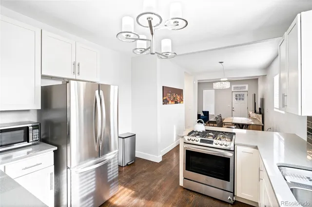 a kitchen with stainless steel appliances granite countertop a stove a refrigerator and a refrigerator
